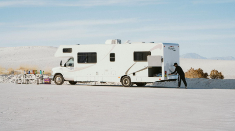 Man loading up his RV during the winter in a desert environment.